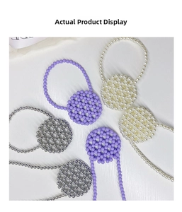 Detailed macro view of handmade acrylic beaded rings in purple, pearl, and silver tones