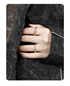 Macro detail of S925 silver and gold-plated rings with textured surface on fingers