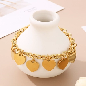 Detail of 18K gold-plated stainless steel chain bracelet with five heart-shaped charms