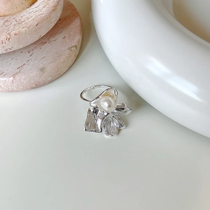 Detail view of irregular silver flower petal ring with a single white pearl centerpiece