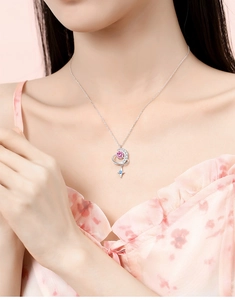 Close-up of s925 silver necklace with moon and star pendant featuring pink and blue stones