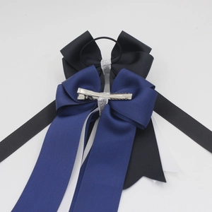 Detail of layered grosgrain bow hair clip with ribbons and metal alligator clip backing
