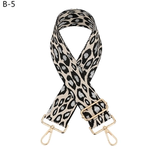 Adjustable leopard print bag strap with gold lobster clasps and metallic silver details
