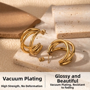 Detail of C-shaped knot earrings with vacuum-plated gold finish on stone display