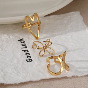 Three-piece set of golden 316L stainless steel rings featuring heart and butterfly designs