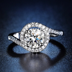Macro shot of silver ring featuring a round center stone and micro-pave setting