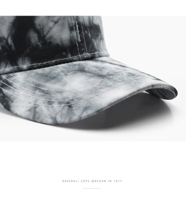 Close-up macro detail of high-quality stitching on a tie-dye vintage baseball cap brim