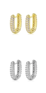 Close-up of gold and silver U-shaped earrings with micro-pave cubic zirconia stones