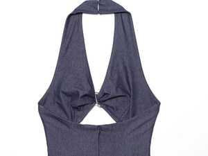 Detail of dark blue denim halter top showing V-neckline and decorative bow buckle
