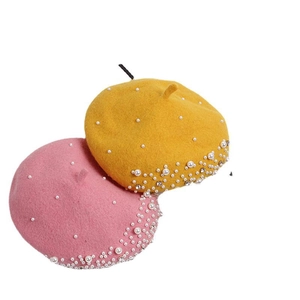 Kids wool beret with pearls and rhinestones in yellow and pink on white background