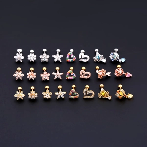 Macro view of diverse zircon stud earrings in silver, gold, and rose gold finishes