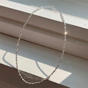 Detailed view of shimmering 925 sterling silver faceted bead necklace in bright sunlight