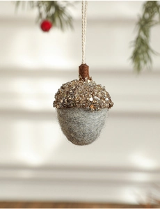 Close-up of felt acorn ornament with golden beadwork and sequins for Christmas