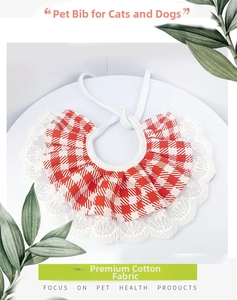 Detailed view of red checkered cotton dog bandana with white lace trim and cotton ties