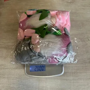 Detailed top view of tulip gnome plush toy weighing 200g on a digital scale