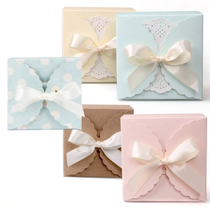 Set of pastel-colored paper gift boxes with lace paper mats and beige ribbon bows