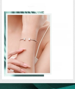 Detail of silver open cuff bracelet with square-cut cubic zirconia and silk texture