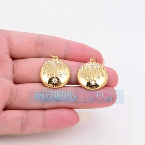 Detail of round star pendant in gold metal with meteor engraving and zircon stones