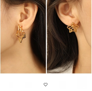 Detailed close-up showing gold spiderweb star earrings worn on ears for size comparison