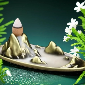 Creative mountain backflow incense burner with golden hills and waterfall smoke effect