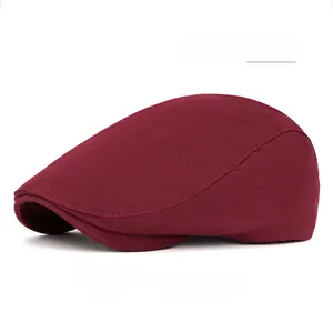 Detail view of the adjustable back buckle on a burgundy cotton flat cap ivy hat