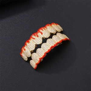 Hip hop gold grillz set with white cubic zirconia and red enamel flame accents