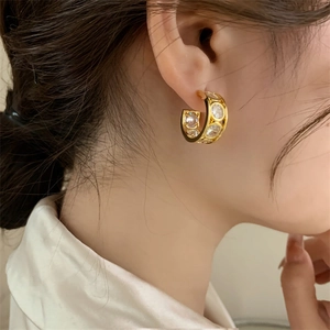 French vintage gold C-shape hoop earrings with round zircon stones worn by model