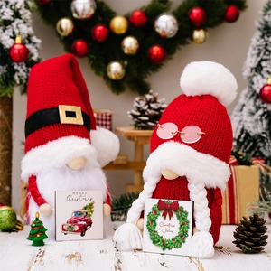Detail of Christmas gnomes with knitted hats and holiday cards in a festive setting
