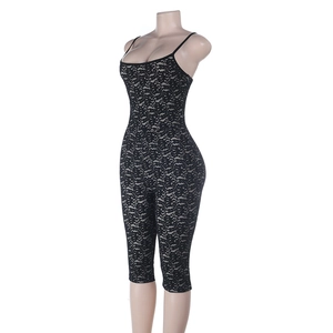Detail of black lace pattern on women's slim fit jumpsuit with spaghetti straps