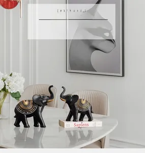 Detailed close-up of modern black elephant resin statues with golden mandala patterns