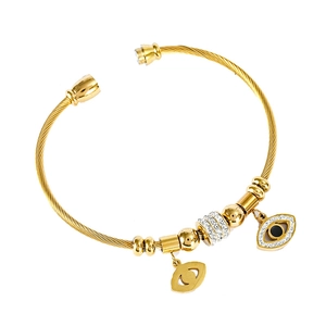 Golden spiral bracelet with Evil Eye charms and white crystal pave in polished finish
