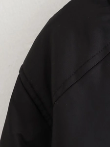 Detail of black bomber jacket showing durable synthetic fiber and double-stitch sewing
