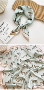 Detail of mint green leopard print satin scarf with elegant striped border texture
