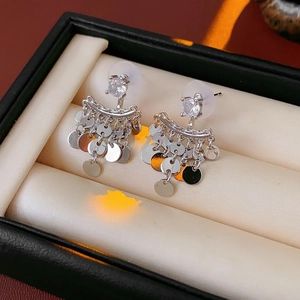 Detail of silver tassel earrings with cubic zirconia and sequins on a velvet jewelry box