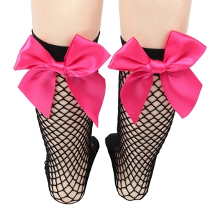 Close-up of black fishnet socks featuring large pink bows on a white background