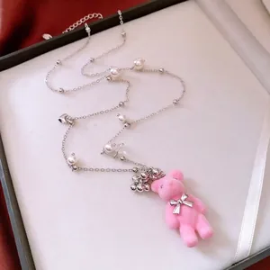 Pink flocked bear pendant necklace with elegant pearl tassels on a silver chain