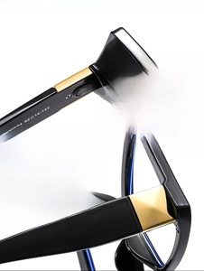 Detail of metal hinge and printed specifications on black butterfly eyeglass frames