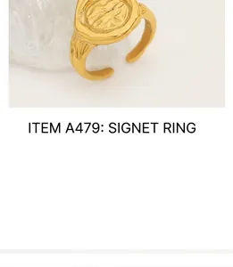 Macro detail of vintage gold medallion ring with irregular embossed texture and open band