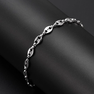 Detailed view of silver coffee bean chain bracelet on black cylindrical stand