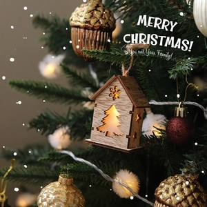 Luminous wooden Christmas tree ornament with warm LED light hanging on a festive tree