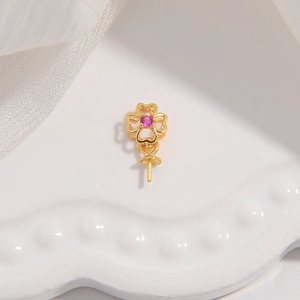 Macro view of a gold-plated S925 silver clover pendant setting with a pink zircon stone