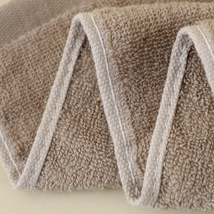 Macro shot of 32-ply cotton towel showing soft terry texture and thick absorbent material