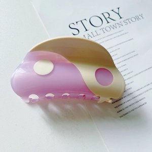 Close-up of Tai Chi Yin Yang hair claw clip in purple and cream acetate material