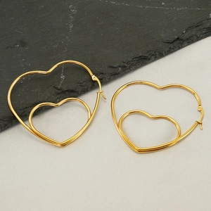 Elegant 18K gold plated stainless steel hollow heart-shaped hoop earrings on slate background