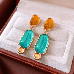 Vintage resin oval drop earrings with amber and turquoise stones in a luxury jewelry box