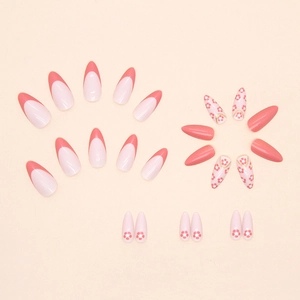 Pink French almond press-on nails set with cute floral patterns and golden accents