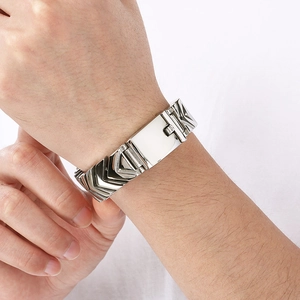 Close-up of men's silver stainless steel snake bone bracelet with geometric V-shaped clasp