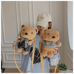 Detailed view of two teddy bear plush crossbody bags shown on model with adjustable straps