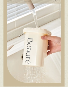 Detail of cream-colored drainage storage box with Beauté text under a water faucet