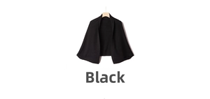 Close-up of lightweight black knit shawl cardigan showing soft texture and fine stitching
